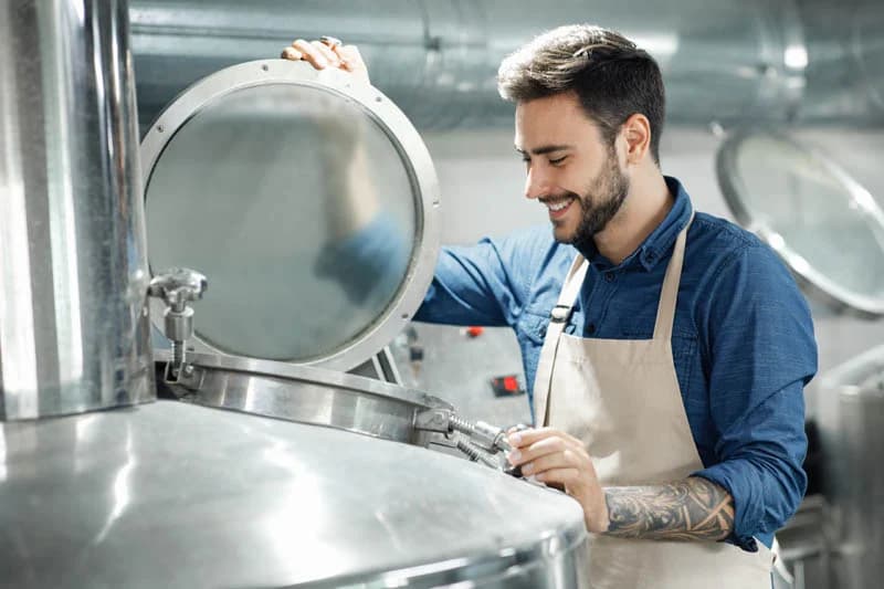 Engineer reviewing a large industrial sight glass assembly